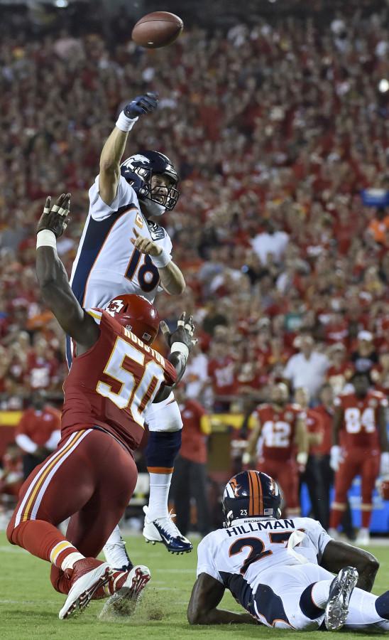 Denver Broncos quarterback Peyton Manning (18) flips a pass into the end zone as Kansas City Chiefs outside linebacker Justin Houston (50) sheds a block by Denver Broncos running back Ronnie Hillman (23) in the second quarter on Thursday, Sept. 17, 2015, at Arrowhead Stadium in Kansas City, Mo. The Broncos won, 31-24. (John Sleezer/Kansas City Star/TNS)