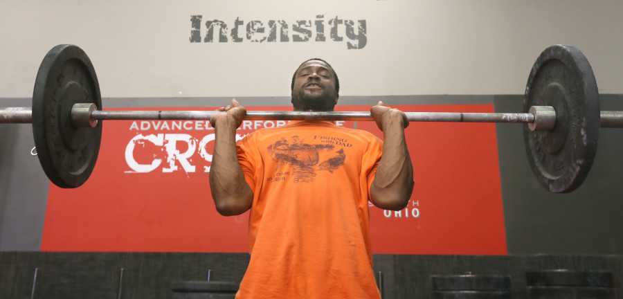 Navy veteran Melvin Smith works on his power clean technique during a workout at Advance Performance and Cross Fit on January 31, 2015, in Wadsworth, Ohio. (Phil Masturzo/Akron Beacon Journal/TNS)
