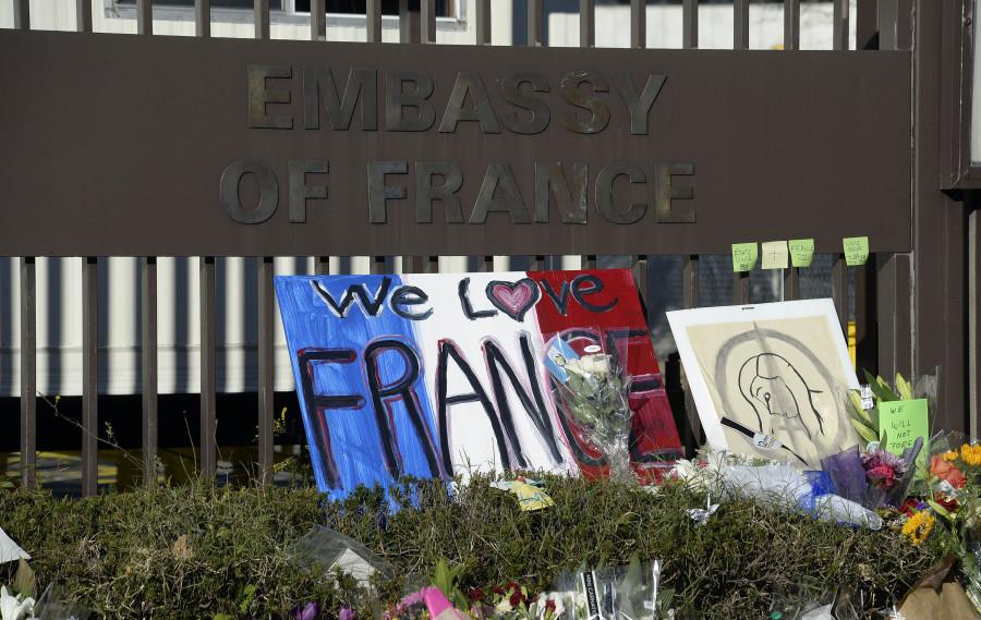 Signs and messages of support have been left at a memorial for the victims of the Paris terror attacks at the Embassy of France in Washington, D.C., on Sunday, Nov. 15, 2015. People gathered in cities around the world to show support for Paris following the coordinated assault that left at least 129 people dead and over 350 injured. (Olivier Douliery/Abaca Press/TNS)