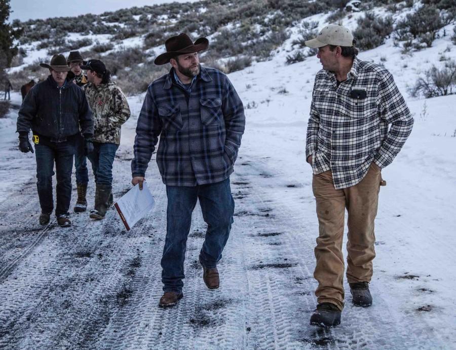 Protest leader Ammon Bundy, holding papers, and others walk up from the Malheur National Wildlife Refuge headquarters compound on Thursday, Jan. 7, 2016, to speak to news reporters about their armed occupation. (Steve Ringman/Seattle Times/TNS)