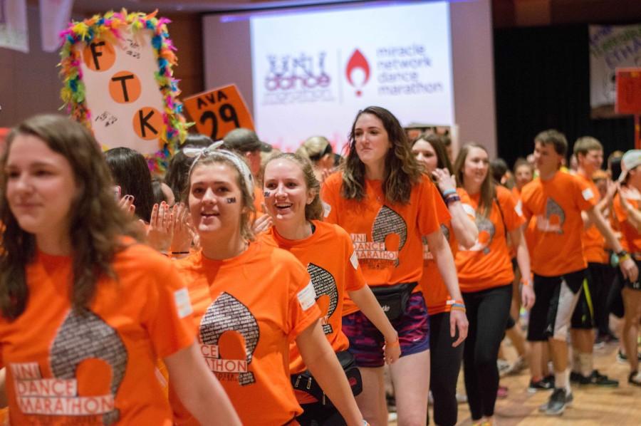UNI Dance Marathon participants high-five each other during the opening ceremony. UNI DM started at noon on Saturday, March 5, and ended at midnight with the Big Reveal, surpassing their fundraising goal by over $65,000