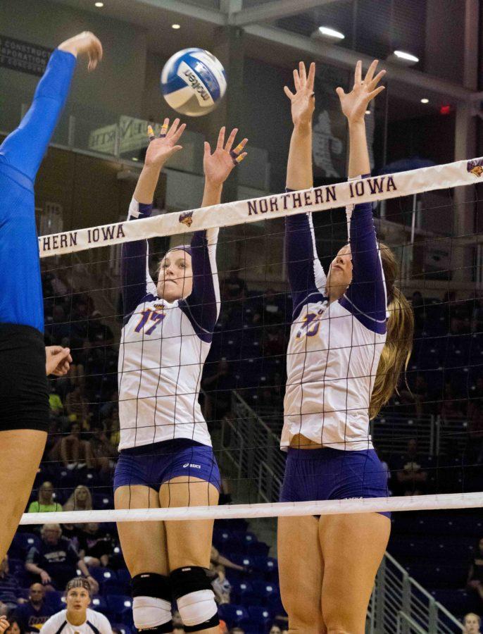 Piper Thomas and Linsey Schulz get up to try and block the opposing teams shot. This year the MVC volleyball tournament will be held here in Cedar Falls. 