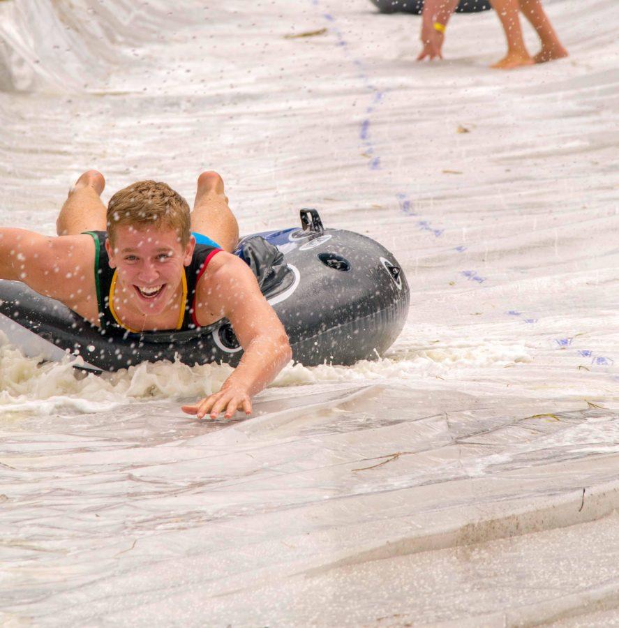 Jace Jirak, sophomore potential business major., slides down the 200 foot long slip and slide. The slide was made of hay bails and plastic sheets