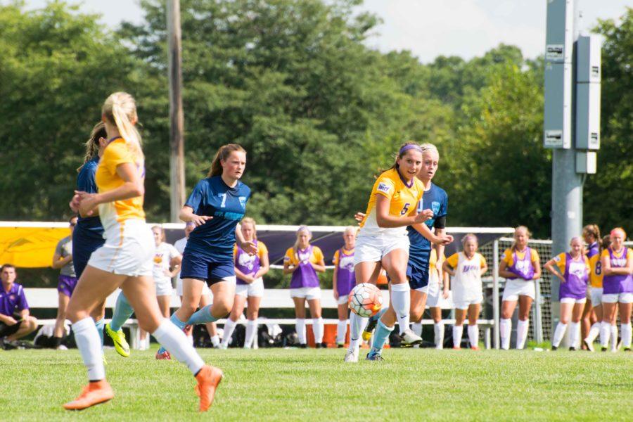 Amber Nieland dribbles the ball downfield despite the tough Saint Ambrose. Nieland scored two goals in UNIs 4-2 victory, one away from the field and the other with the help of an assist from Julianne Trizzino. 