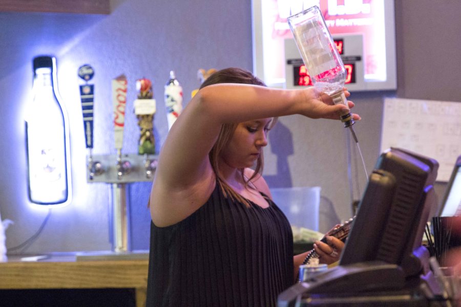 A bartender mixes a drink at Beck's on College Hill. Beck's had a send-off party for the business on Saturday, Aug. 20. A line stretched out the door for most of the night. 