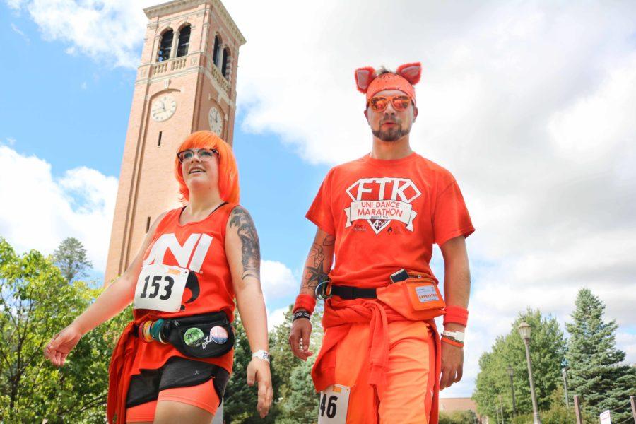 Runners jogged past the campanile with their orange attire during the UNI Dance Marathon 5k on Saturday afternoon