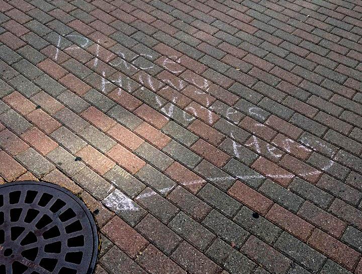 One chalking reads Place Hillary Votes Here with an arrow leading towards a manhole cover. Both UNI Democrats and UNI College Republicans say they do not stand for this behavior.