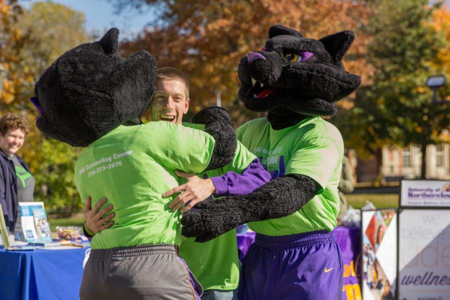 Hunter Flesch, student body president, gets hugged by TC and TK at the kick-off. 