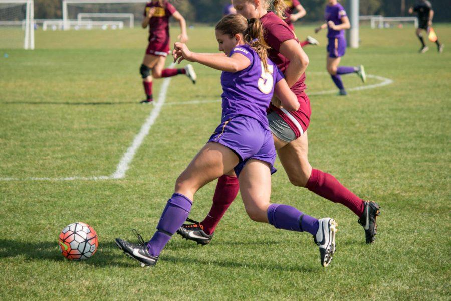 Amber Nieland (5) dribbles up-field with a Loyola defender right by her side. Nieland saw a great opportunity when she passed the ball to Kelsey Yarrow who scored the fourth goal of the night. 