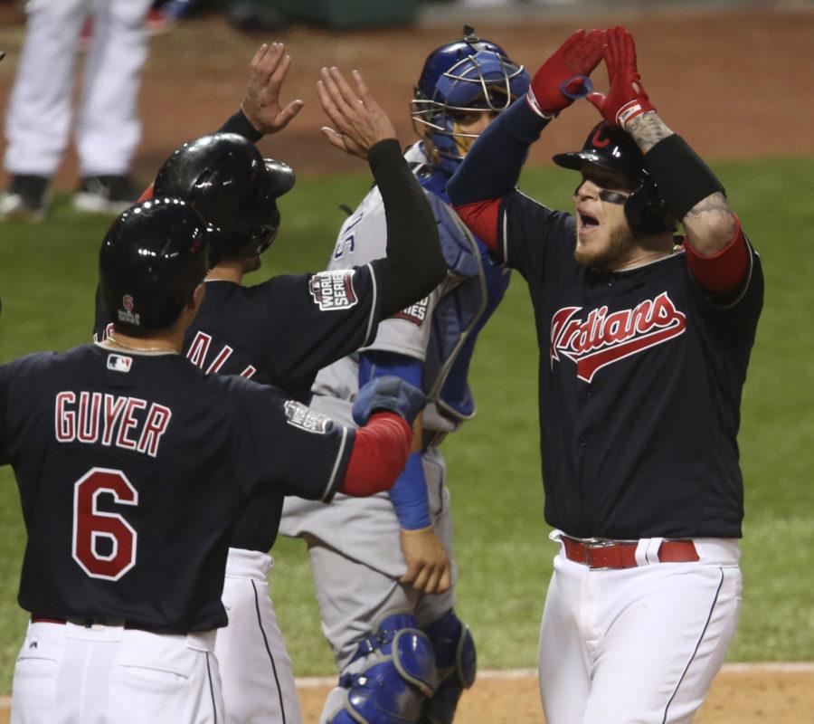 The Cleveland Indians Roberto Perez (right) is congratulated by fellow teammates Lonnie Chisenhall and Brandon Guyer (6) after hitting a three-run home in Game 1 of the World Series against the Chicago Cubs. 