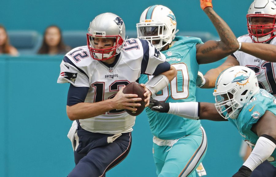 Tom Brady (12) escapes the Miami Dolphin defense and escape from Florida with a 35-14 victory. The Patriots finished the regular 2016-2017 season with a final record of 14-2.
