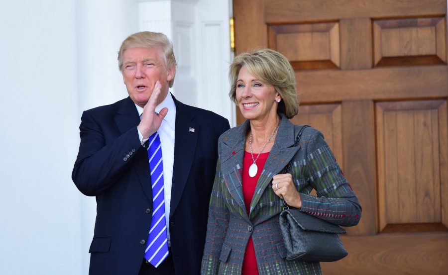 Donald Trump (left) stands with his pick for Secretary of Education, Betsy DeVos (right). DeVos, who advocates for the so-called school choice voucher system.