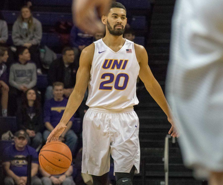 Senior Jeremy Morgan (20) walks the ball up the court against the Southern Illinois Salukis. Morgan currently leads the team with 352 points this season. 