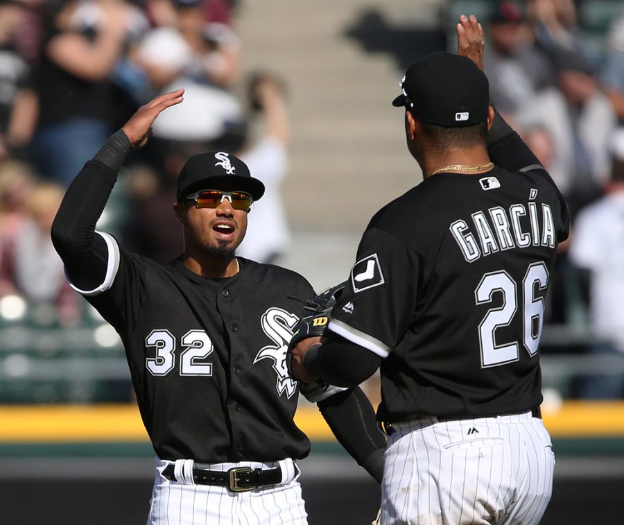 Jacob May (32) and Avisail Garcia (26) celebrate their 6-2 win against Joe Mauer and the Minnesota Twins