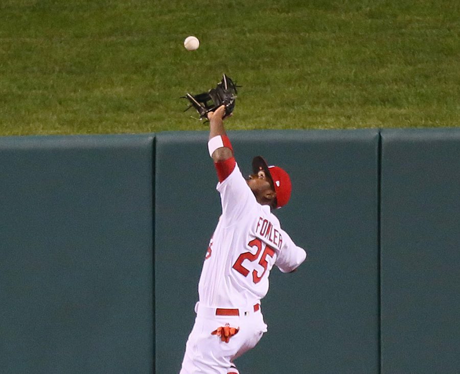 St. Louis Cardinals center fielder, Dexter Fowler, catches a fly ball off the wall, hit by the Chicago Cubs Javier Baez in the ninth inning