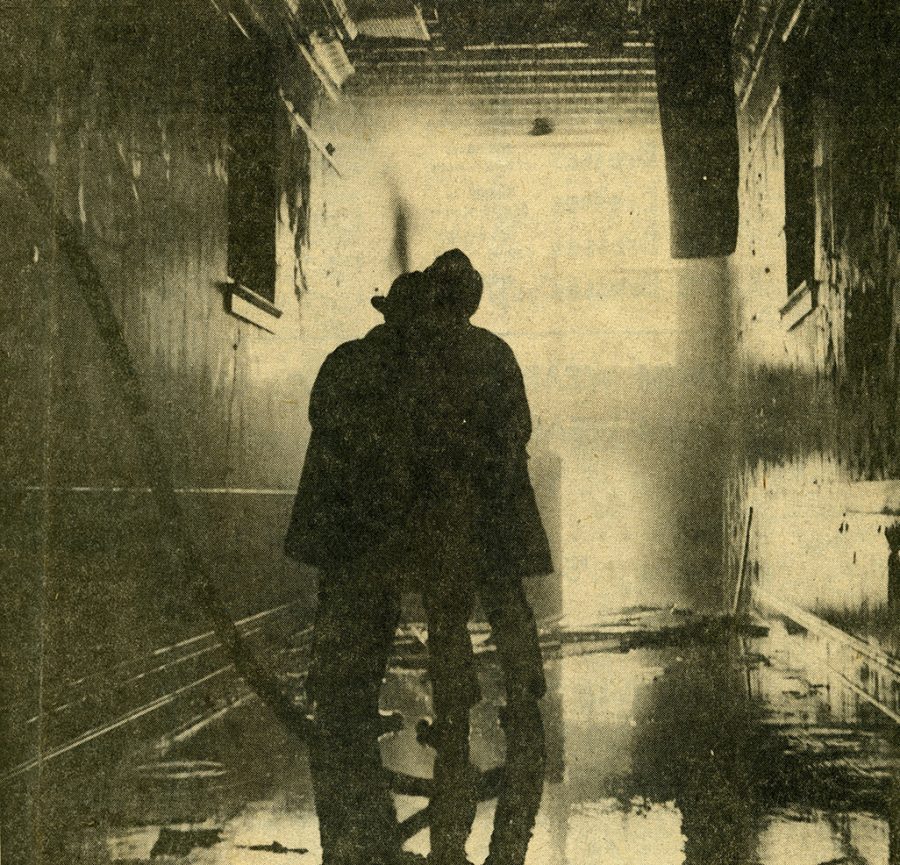 Two firefighters in the second story corridor of Old Central Hall attempt to quell the fire. The blaze would destroy Old Central Hall, the oldest building on campus at the time of the fire and the founding building of the Iowa State Normal School, which would later become UNI.