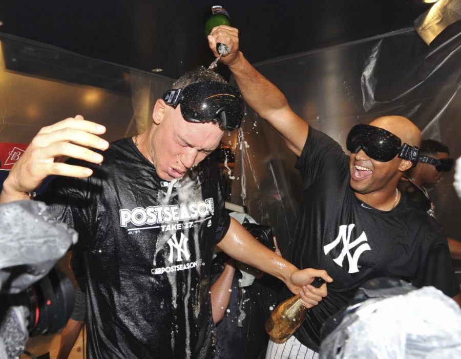Aaron Judge (left) is doused by CC Sabathia (right) after an 8-4 American Wild Card win at Yankee Stadium against the Minnesota Twins.