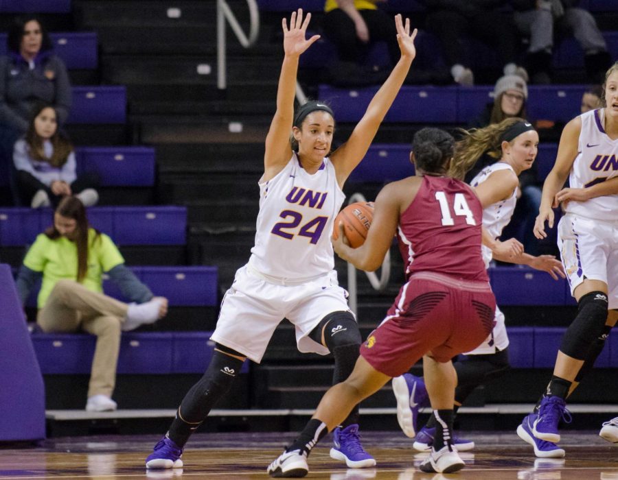 Junior guard Mikaela Morgan tries to block a shot from a player on the opposing team.