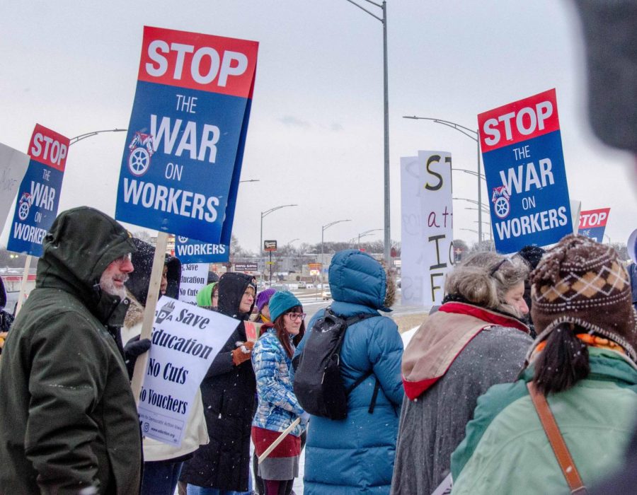 Protesters from various organizations, including UNI United Faculty and the Iowa State Education Association, picketed Gov. Reynolds visit on Friday.