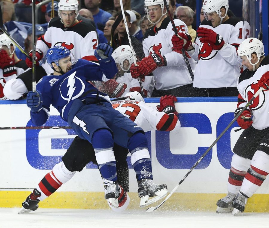 Tampa Bay center Cedric Paquette (left) collides with New Jerseys Stefen Noesen (23) during their first round playoff game on Saturday.
