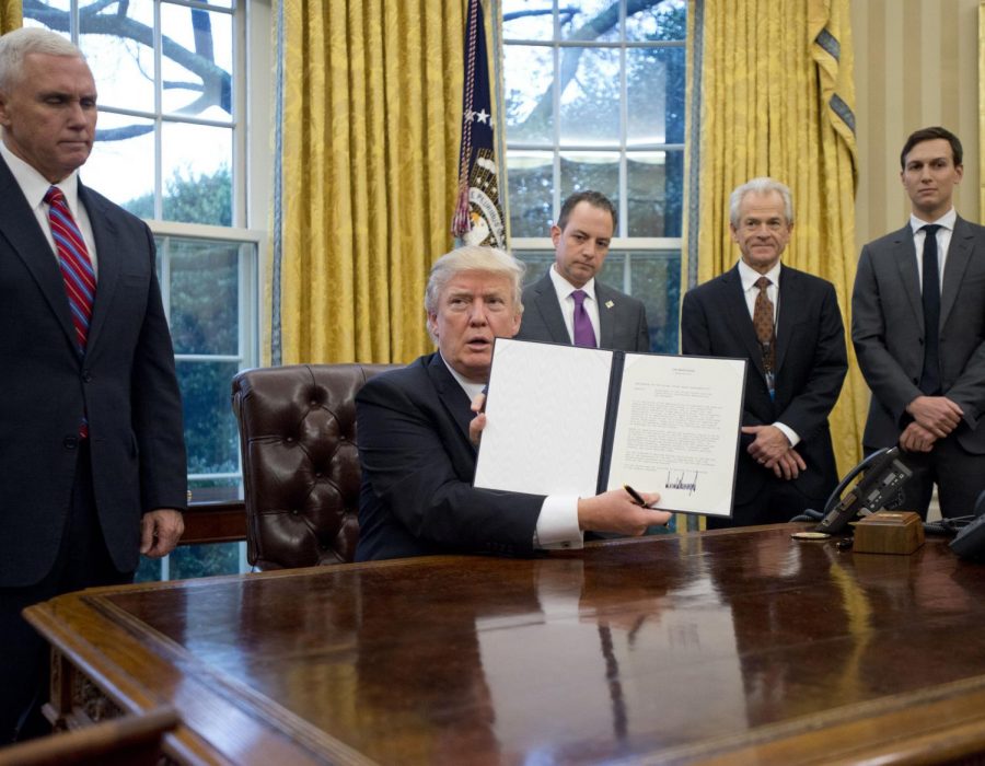President Trump with his executive order to withdraw from the Trans Pacific Partnership on Jan. 23, 2017.