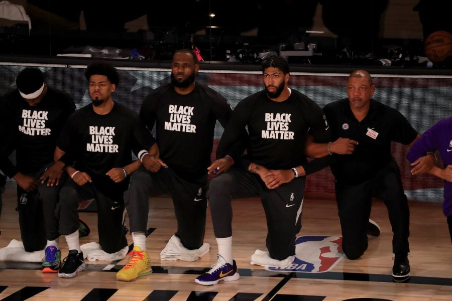 NBA+players+such+as+LeBron+James+%28middle%29+and+others+have+been+outspoken+about+recent+racial+unrest+in+the+United+States+this+year.