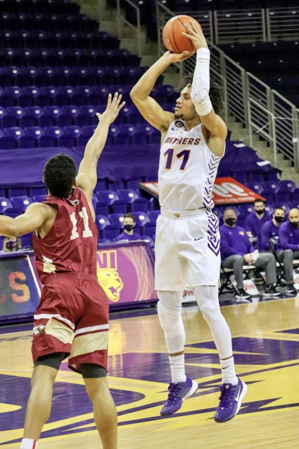 UNI senior Trae Berhow shoots over the Kohawk's Greg Hall. Berhow finished the game with 18 points and four made three pointers in the win.