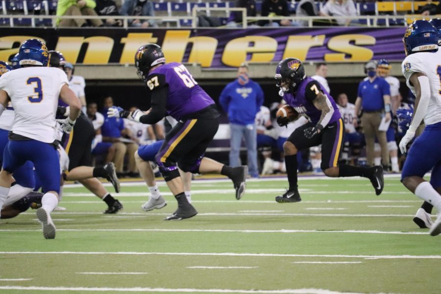 UNI graduate transfer running Dom Williams carries the ball with offensive linemen Erik Sorensen leading the way. Williams, a transfer from the University of Kansas, ran for 35 yards in the Panthers 24-20 loss to SDSU last Friday.