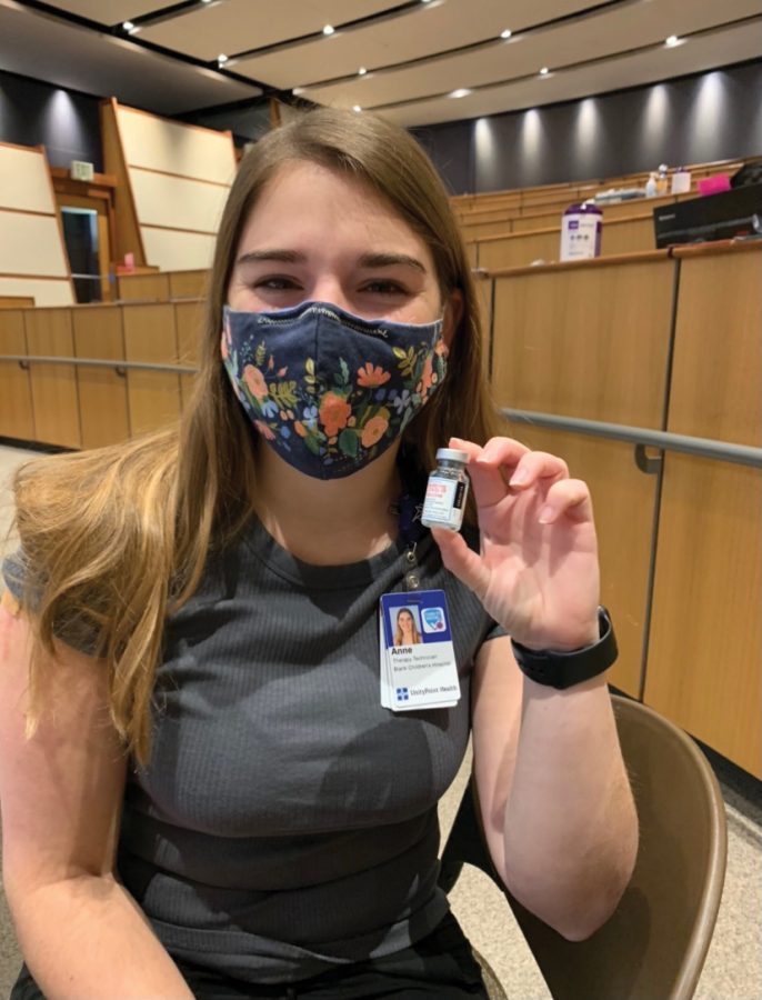 Senior Anne Gradoville holds up her Moderna vaccine after she was vaccinated while working at UnityPoint Hospital in Des Moines.