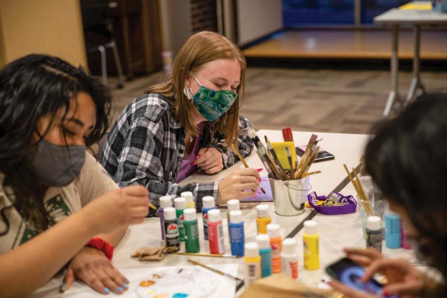 Students participate in an arts and crafts event hosted by CMA and the Northern Iowa Feminists.