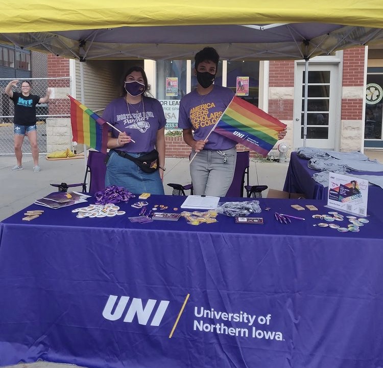 UNI LGBTQ+ members show off their UNI gear and pride merchandise Saturday. Many informational booths were set up for attendees. 