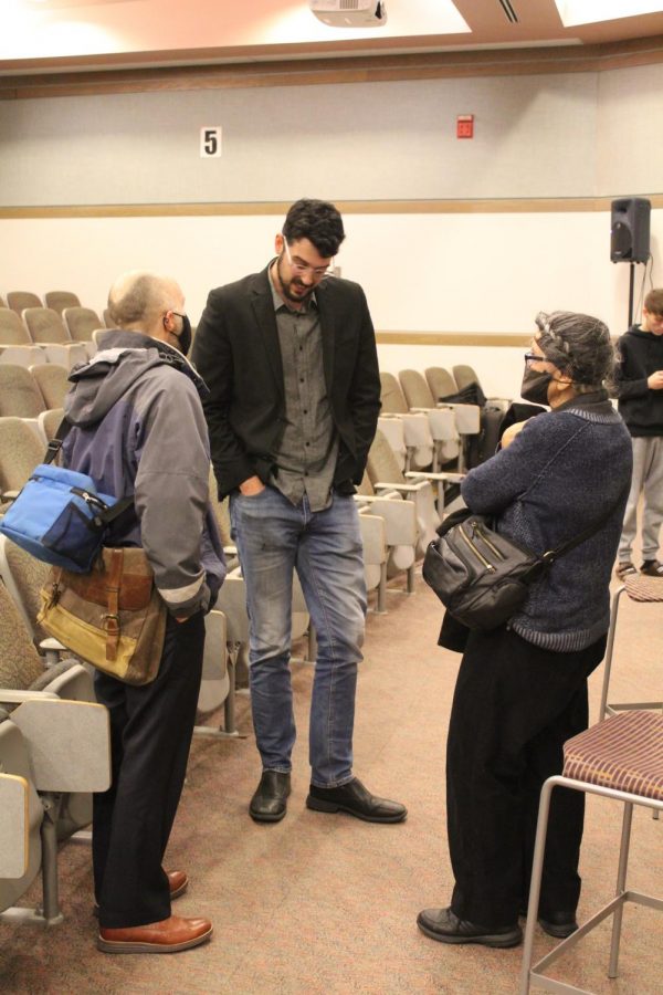 Tom Cullen (pictured above, center), talks with audience members after the screening of Storm Lake.