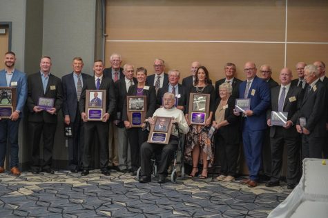 The 2022 class of the UNI Athletics Hall of Fame posing with their plaques. This class includes seven individuals as well as the 1963-64 mens basketball team. 