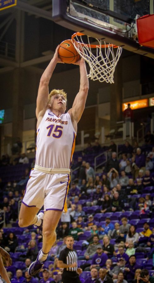 Michael Duax (15) dunks the ball during UNIs loss to McNeese State. Duax recorded a double-double on Friday, the first of his career.