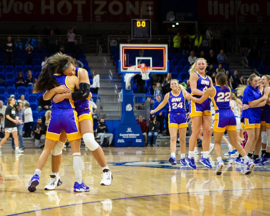 Kam Finley hugs Maya McDermott while the rest of the Panthers celebrate in the background following the conclusion of UNIs 70-69 victory over Drake. McDermott led the Panthers with 19 points and six assists while also making the game-winning shot.