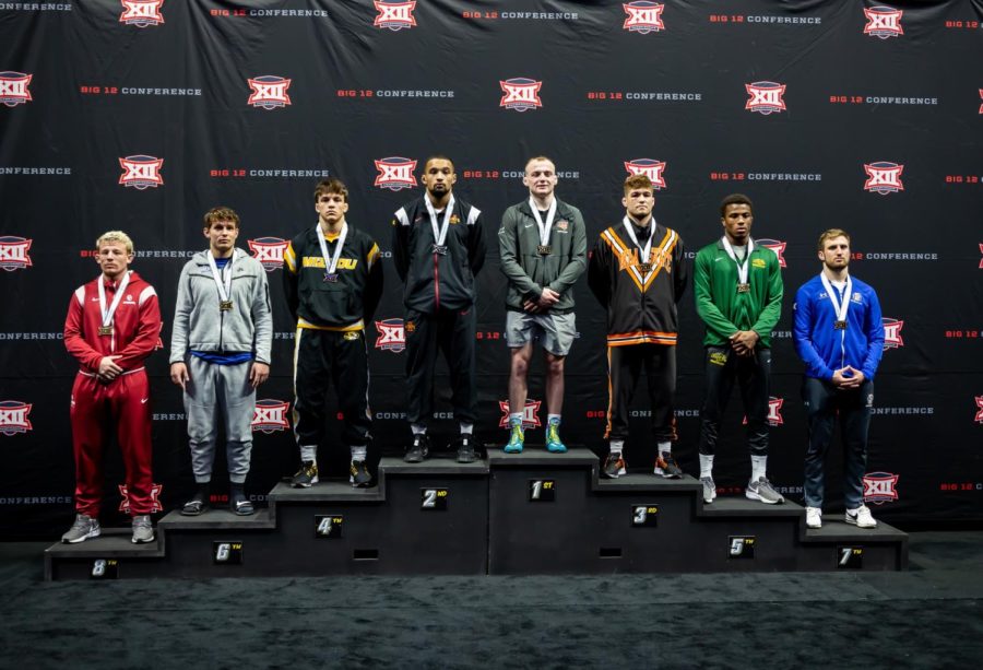 Parker Keckeisen stands atop the podium after claiming the Big 12 Conference Championship in the 184 pound weight class, his third consecutive conference title. 