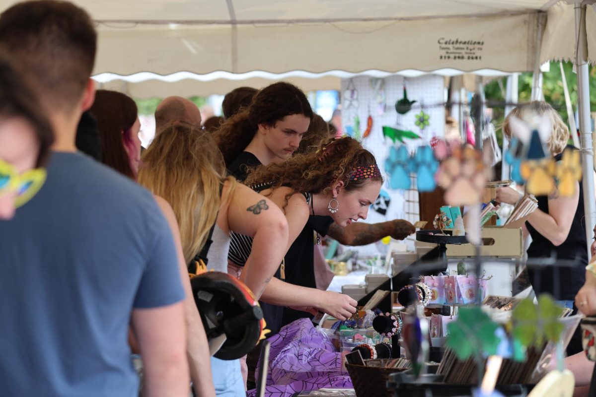 UNI students peruse the vendors at the Pear Fair. The fair offered 30+ vendors this year as well as food trucks for patrons at the intersection of 22nd and College St.