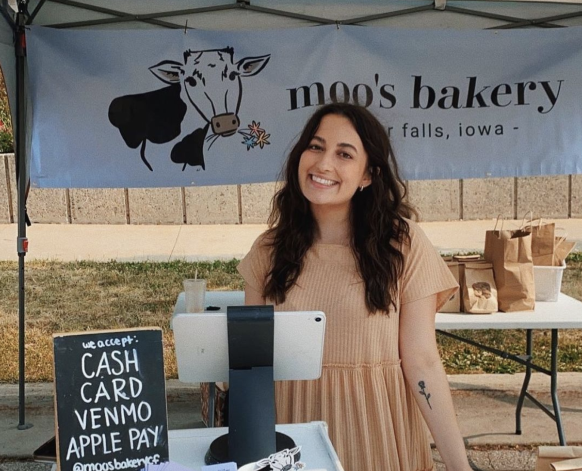 Maddie Palmersheim, 2021 UNI grad, holds her vendor booth at the Cedar Valley Farmers Market.