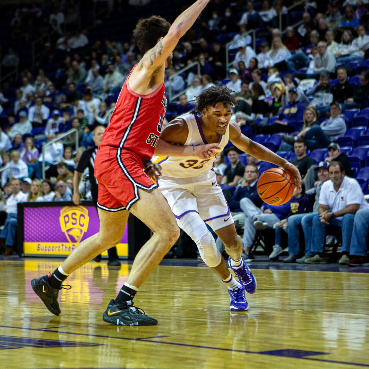 Tytan Anderson marches to the basket while shaking off a defender.