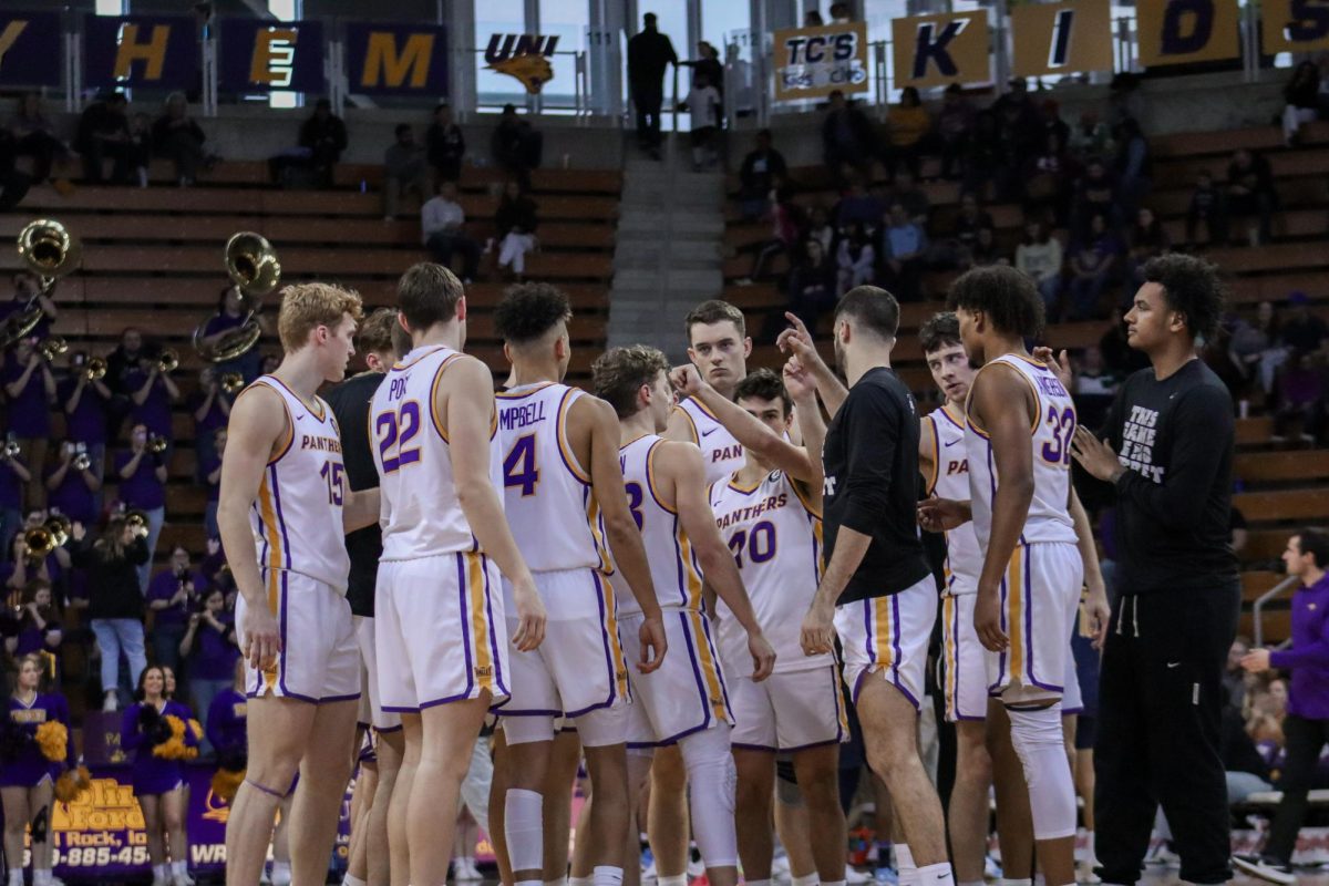 The Panthers meet for a huddle in the middle of a game.