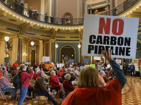 Landowners protest the carbon pipeline project under the golden dome of the capitol in Des Moines.