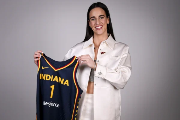 Caitlin Clark poses with her Indiana Fever jersey after being drafted by the
team earlier this month.