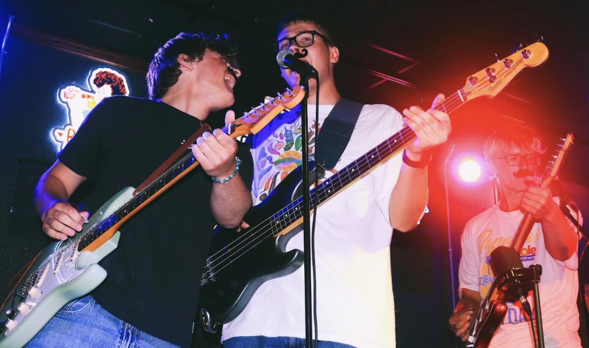 Guitar and vocalists, Braden Sabin (left),  Breven Biermann (right), and bass guitar and vocals, Leo Burchett (middle) shredding together as the rock band, Bagel Steak.