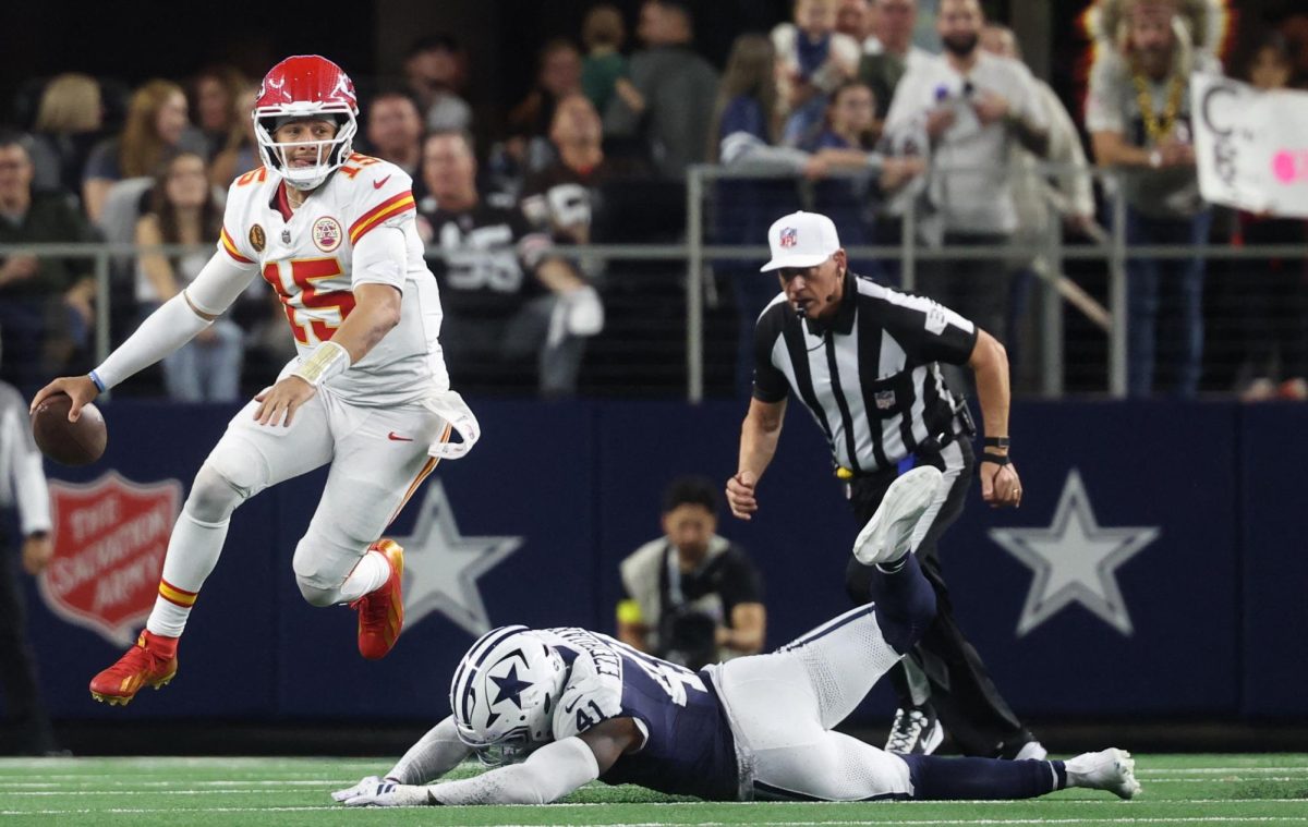 Kansas City Chiefs quarterback Patrick Mahomes (15) escapes the pressure from Dallas Cowboys defensive end Donovan Ezeiruaku (41) during the fourth quarter at AT&T Stadium. 