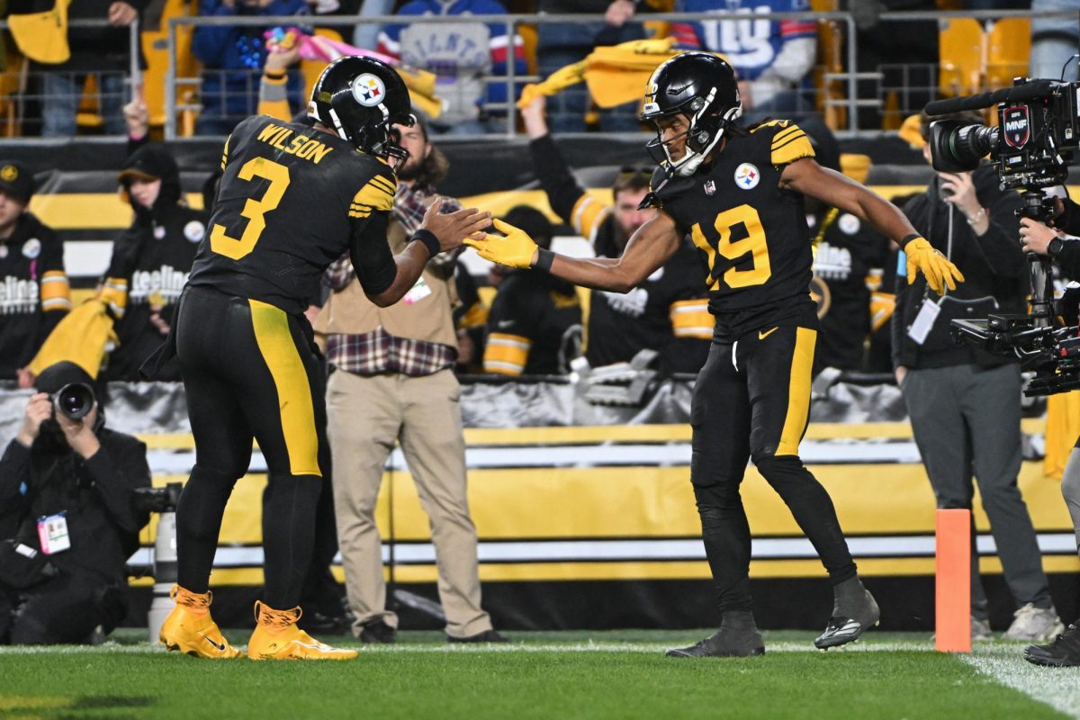 Oct 28, 2024; Pittsburgh, Pennsylvania, USA; Pittsburgh Steelers Calvin Austin III (19) celebrates a 29-yard touchdown with quarterback Russell Wilson (3) against the New York Giants during the fourth quarter at Acrisure Stadium. 